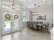 Bright dining room featuring a large table and chandelier at 10622 Cheval Pl, Lakewood Ranch, FL 34202