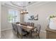 Formal dining room with wood table and gray chairs at 10622 Cheval Pl, Lakewood Ranch, FL 34202