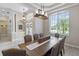 Bright dining room featuring a large table and chandelier at 10622 Cheval Pl, Lakewood Ranch, FL 34202