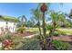 Landscaped front yard with lush tropical plants at 10622 Cheval Pl, Lakewood Ranch, FL 34202