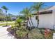 Landscaped front yard with palm trees and manicured bushes at 10622 Cheval Pl, Lakewood Ranch, FL 34202