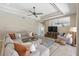 Spacious living room featuring a sectional sofa and large TV at 10622 Cheval Pl, Lakewood Ranch, FL 34202