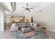 Bright living room with a sectional sofa and view into the kitchen at 10622 Cheval Pl, Lakewood Ranch, FL 34202