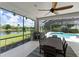 Spacious screened patio with dining area, overlooking pool and lake at 10622 Cheval Pl, Lakewood Ranch, FL 34202