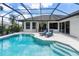 Relaxing pool and spa with lounge chairs and screened enclosure at 10622 Cheval Pl, Lakewood Ranch, FL 34202