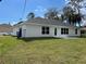 Backyard view of a one-story house with a grassy lawn at 2968 Yacolt Ave, North Port, FL 34286