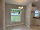 Cozy dining room area with modern light fixture and natural light from the backyard view at 2968 Yacolt Ave, North Port, FL 34286