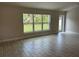 The spacious living room features tile flooring and natural light from a picture window and door at 2968 Yacolt Ave, North Port, FL 34286