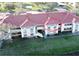 Aerial view of condo building with red tile roofs and landscaping at 1050 Villagio Cir # 206, Sarasota, FL 34237