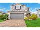 Two-story home with gray siding, a two-car garage and landscaping at 11868 Little River Way, Parrish, FL 34219