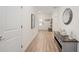 Bright foyer with wood-look floors and decorative console table at 11868 Little River Way, Parrish, FL 34219