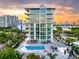 Luxury high-rise condo building with pool and sunset views at 111 Golden Gate Pt # 201, Sarasota, FL 34236