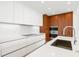 Modern kitchen with white cabinets, stainless steel appliances and sink at 111 Golden Gate Pt # 201, Sarasota, FL 34236