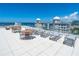 Enjoy water views from this rooftop deck with seating and tables at 111 Golden Gate Pt # 201, Sarasota, FL 34236