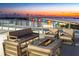 Relaxing rooftop terrace with fire pit and seating at 111 Golden Gate Pt # 201, Sarasota, FL 34236