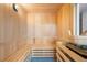 Relaxing wooden sauna with bench seating at 111 Golden Gate Pt # 201, Sarasota, FL 34236