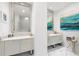 Spa-like bathroom with double vanity and marble floors at 1155 N Gulfstream Ave # 208, Sarasota, FL 34236