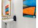 Small bathroom with pedestal sink and artwork at 1155 N Gulfstream Ave # 208, Sarasota, FL 34236