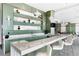 Modern community bar with green cabinetry, marble counters, and pendant lighting at 1155 N Gulfstream Ave # 208, Sarasota, FL 34236