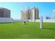 Artificial turf dog park with modern building in the background at 1155 N Gulfstream Ave # 208, Sarasota, FL 34236