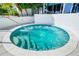 Relaxing circular hot tub with steps and handrail at 1155 N Gulfstream Ave # 208, Sarasota, FL 34236