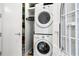 Well-appointed laundry room with washer, dryer, and storage at 1155 N Gulfstream Ave # 208, Sarasota, FL 34236