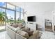 Spacious living room featuring a large sectional sofa and water views at 1155 N Gulfstream Ave # 208, Sarasota, FL 34236