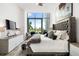 Main bedroom with king-size bed and stunning city views at 1155 N Gulfstream Ave # 208, Sarasota, FL 34236