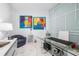 Bright home office with glass desk and modern art at 1155 N Gulfstream Ave # 208, Sarasota, FL 34236