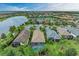 Aerial view of community with lake and homes, showcasing desirable location and landscape at 17006 Hampton Falls Ter, Lakewood Ranch, FL 34202