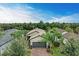 Aerial view of single Gathering home with gray garage door and brick driveway at 17006 Hampton Falls Ter, Lakewood Ranch, FL 34202