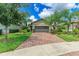 House with a two-car garage and brick paver driveway, surrounded by landscaping at 17006 Hampton Falls Ter, Lakewood Ranch, FL 34202