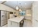 Modern kitchen with white cabinets, stainless steel appliances, and large island at 17006 Hampton Falls Ter, Lakewood Ranch, FL 34202