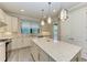 Modern kitchen with white cabinets, stainless steel appliances and large island at 17006 Hampton Falls Ter, Lakewood Ranch, FL 34202