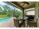 Screened-in lanai with pool, patio furniture, and grill at 17006 Hampton Falls Ter, Lakewood Ranch, FL 34202