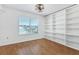 Bedroom with wood floors, built-in shelving and window at 3125 57Th Avenue E Cir, Bradenton, FL 34203