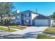 Two-story house with a gray exterior, blue door and a new roof at 3125 57Th Avenue E Cir, Bradenton, FL 34203