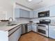 Kitchen with stainless steel appliances and light blue cabinets at 3125 57Th Avenue E Cir, Bradenton, FL 34203