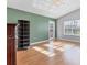 Living room with wood floors, green accent wall and door to patio at 3125 57Th Avenue E Cir, Bradenton, FL 34203