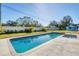 Inviting rectangular pool with a spa, surrounded by a grassy yard at 3125 57Th Avenue E Cir, Bradenton, FL 34203