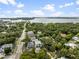 Aerial view of a waterfront community, showcasing new construction homes and lush greenery at 3464 Camino Real, Sarasota, FL 34239