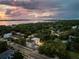 Aerial view of modern home near water, showcasing neighborhood at 3464 Camino Real, Sarasota, FL 34239