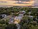 Aerial view of modern home and surrounding neighborhood at sunset at 3464 Camino Real, Sarasota, FL 34239