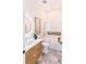 Modern bathroom with floating vanity, bathtub and marble flooring at 3464 Camino Real, Sarasota, FL 34239