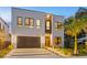 Modern home with stylish garage and lighting at 3464 Camino Real, Sarasota, FL 34239