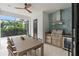 Outdoor kitchen with stainless steel grill and dining area at 3464 Camino Real, Sarasota, FL 34239