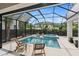 Enclosed pool and spa area with outdoor seating at 3464 Camino Real, Sarasota, FL 34239