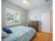 Guest bedroom with wood floors, dresser, and window with blinds at 4532 Shark Dr, Bradenton, FL 34208