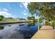 Beautiful view of the canal with private dock and lush greenery at 4532 Shark Dr, Bradenton, FL 34208