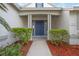 Inviting front entrance with blue door and manicured landscaping at 4532 Shark Dr, Bradenton, FL 34208